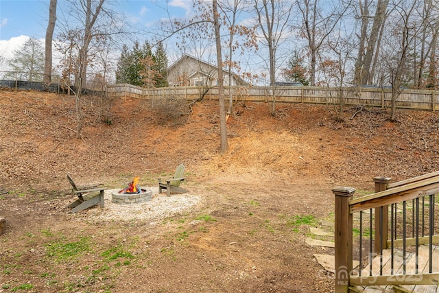 view of yard featuring an outdoor fire pit and a fenced backyard