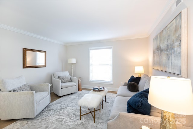 living room featuring baseboards, wood finished floors, and ornamental molding