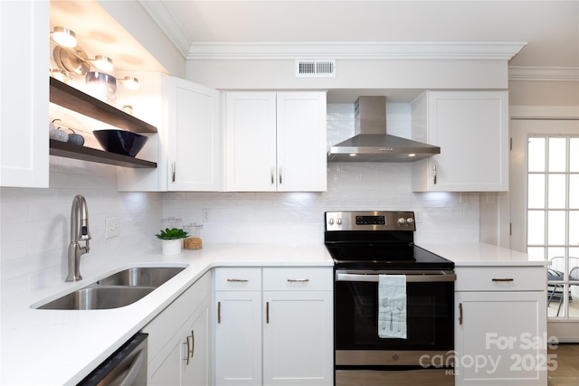 kitchen featuring visible vents, a sink, wall chimney range hood, appliances with stainless steel finishes, and open shelves