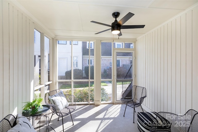 sunroom / solarium featuring a ceiling fan