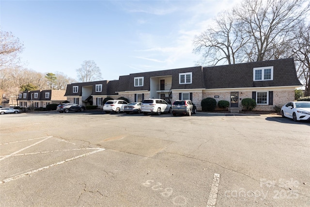 uncovered parking lot with a residential view