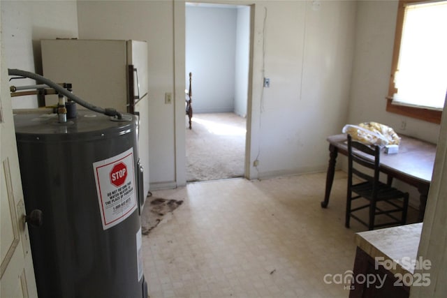 interior space featuring light floors and water heater