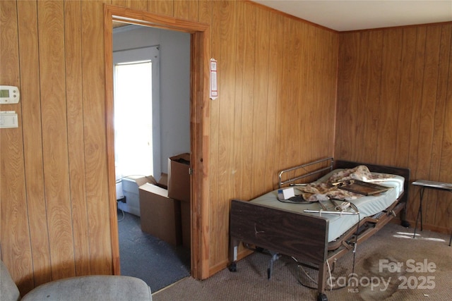 dining area with carpet floors and wood walls