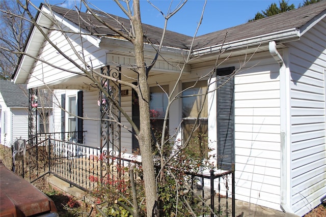 view of side of property with a shingled roof