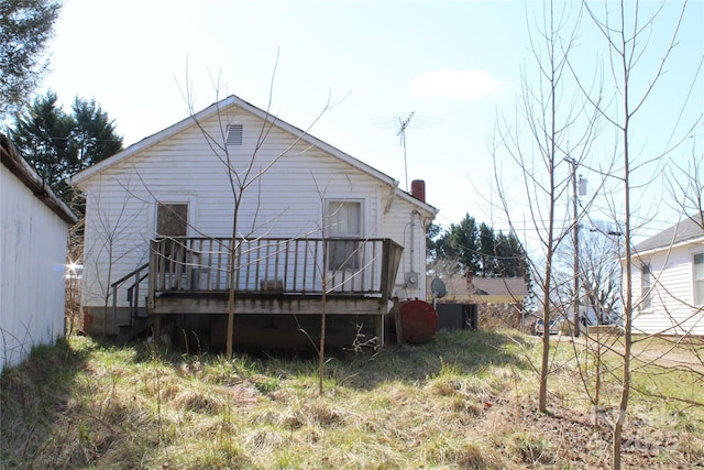 rear view of house featuring a deck