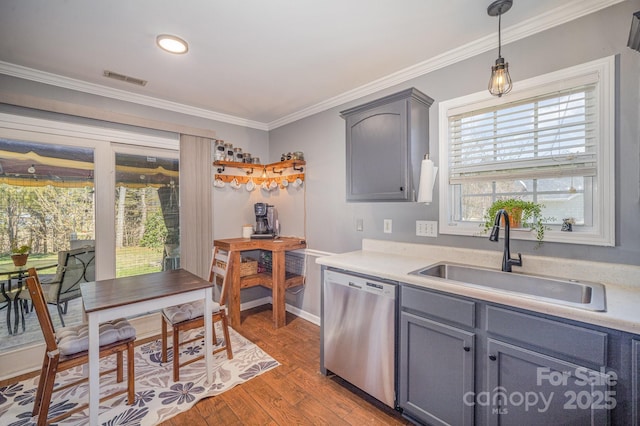 kitchen with visible vents, gray cabinets, a sink, stainless steel dishwasher, and crown molding