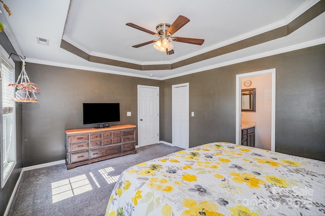 bedroom featuring visible vents, crown molding, baseboards, a tray ceiling, and carpet floors