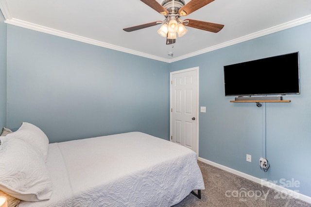 carpeted bedroom featuring ceiling fan, baseboards, and ornamental molding