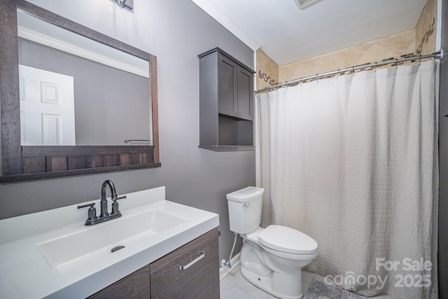 bathroom with vanity, curtained shower, and toilet