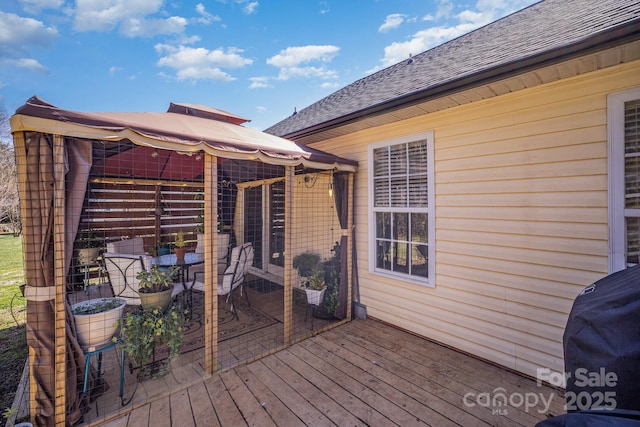 deck with an outbuilding and a grill