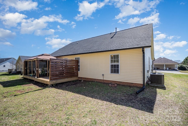 back of house featuring a wooden deck, roof with shingles, a gazebo, cooling unit, and a yard