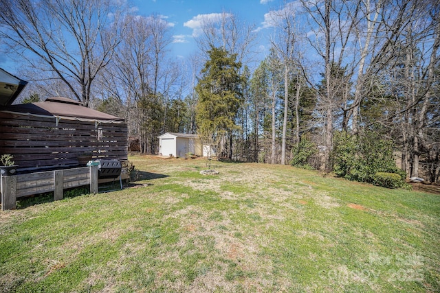 view of yard featuring a storage shed and an outdoor structure