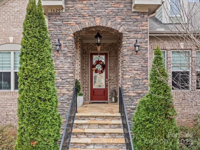 property entrance with brick siding and stone siding