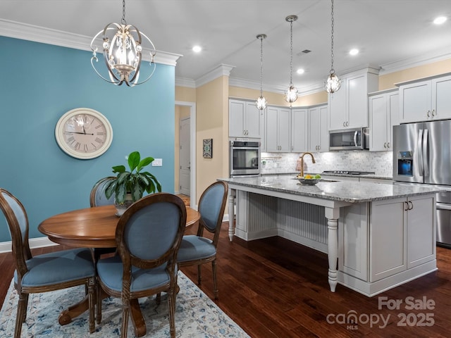 kitchen with crown molding, light stone countertops, dark wood-type flooring, and stainless steel appliances