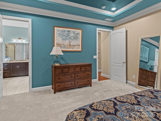 bedroom with light carpet, ornamental molding, a sink, a tray ceiling, and baseboards