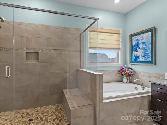 full bathroom featuring recessed lighting, vanity, a bath, and a shower stall