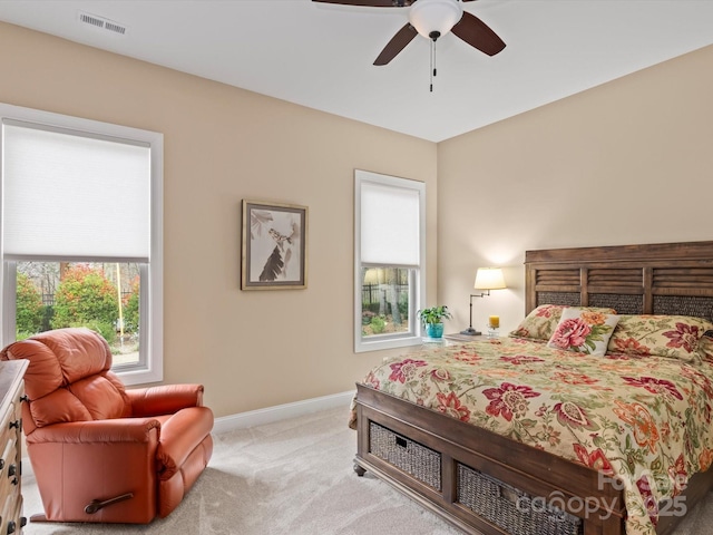 bedroom featuring visible vents, carpet flooring, baseboards, and multiple windows