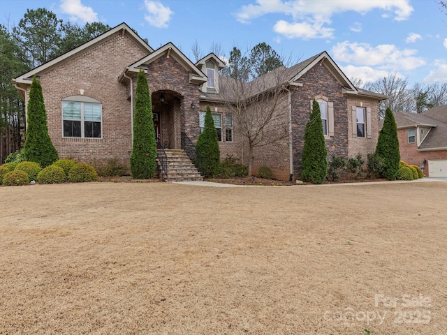 view of front of home featuring brick siding