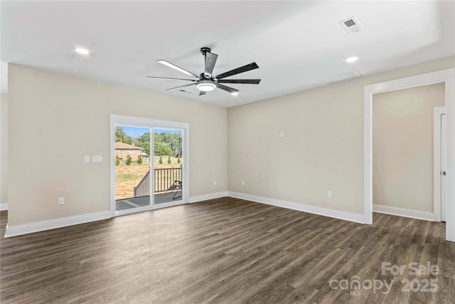 unfurnished room with visible vents, baseboards, dark wood-style floors, and a ceiling fan