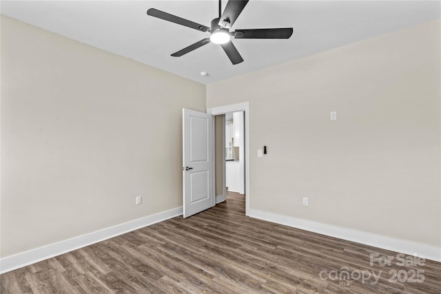 unfurnished room with a ceiling fan, baseboards, and wood finished floors