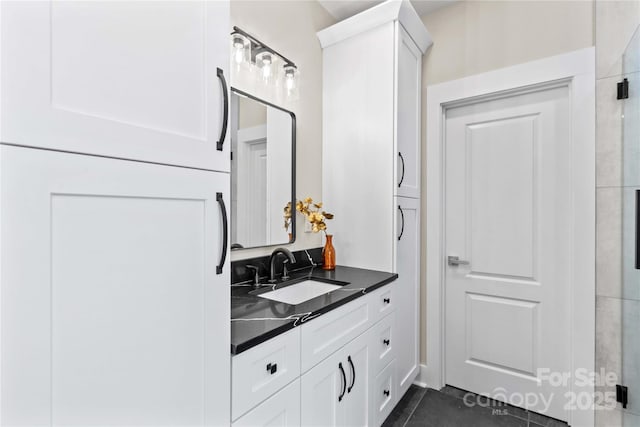 bathroom with tile patterned floors and vanity