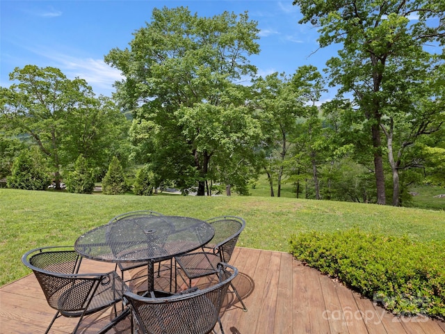 609 N Fork Rd, Black Mountain, NC 28711 - deck featuring a lawn, outdoor dining area, and view of scattered trees