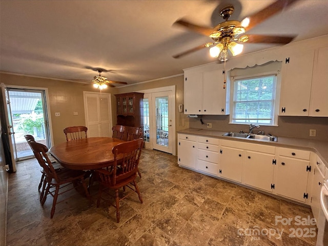 dining area featuring a ceiling fan and crown molding