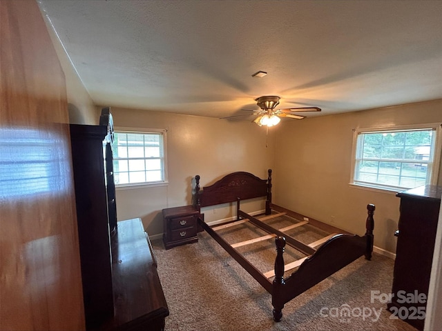 carpeted bedroom with a textured ceiling and ceiling fan