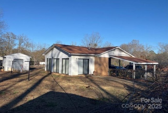 rear view of property with an outdoor structure