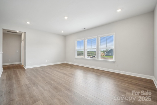 1439 Hubert Graham Way, Tega Cay, SC 29708 - spare room with wood finished floors, baseboards, and recessed lighting