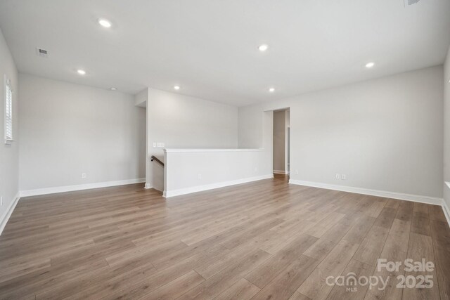 1439 Hubert Graham Way, Tega Cay, SC 29708 - spare room featuring wood finished floors, recessed lighting, and baseboards