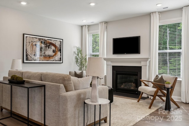 1439 Hubert Graham Way, Tega Cay, SC 29708 - living room with wood finished floors, a fireplace with flush hearth, recessed lighting, and baseboards