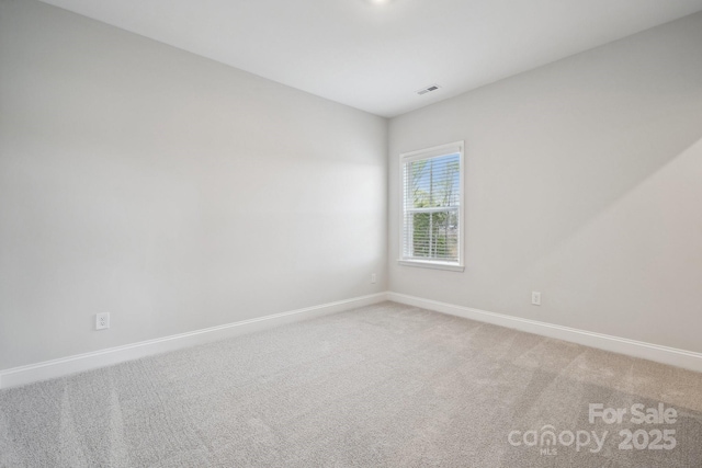 1439 Hubert Graham Way, Tega Cay, SC 29708 - spare room featuring baseboards and light colored carpet