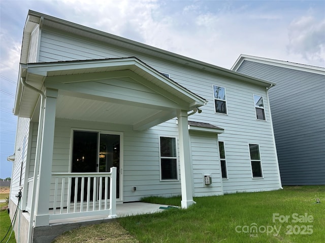 1439 Hubert Graham Way, Tega Cay, SC 29708 - rear view of house featuring a lawn and a porch