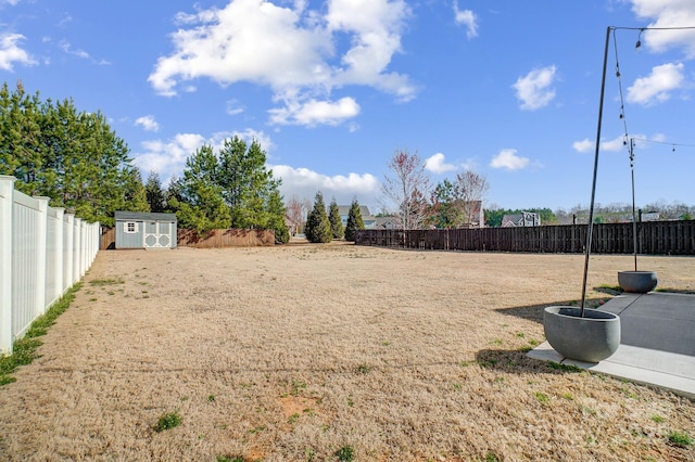 view of yard featuring a storage shed, an outdoor structure, a fenced backyard, and a patio