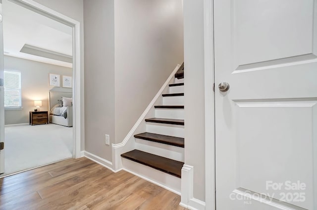 stairs featuring baseboards and wood finished floors