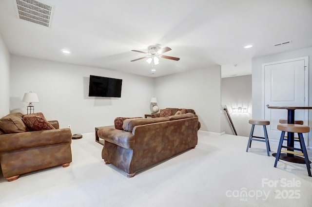 carpeted living room with visible vents, a ceiling fan, and recessed lighting