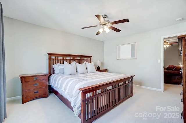 bedroom featuring baseboards, light carpet, and ceiling fan