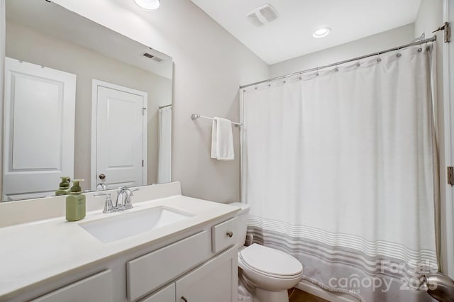 full bath featuring vanity, toilet, and visible vents