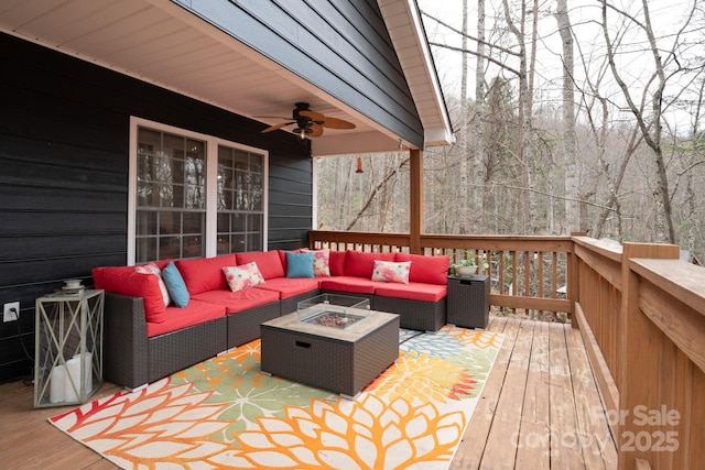 deck featuring an outdoor living space with a fire pit and ceiling fan