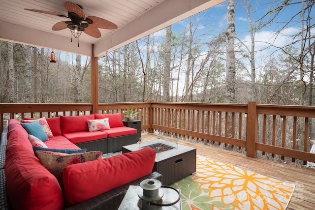 wooden terrace featuring an outdoor living space with a fire pit and ceiling fan