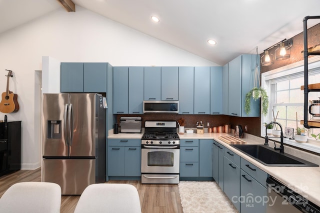 kitchen featuring a sink, blue cabinetry, and stainless steel appliances