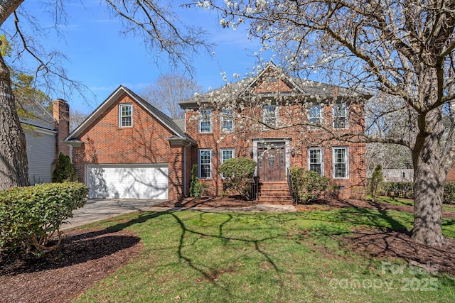 view of front of house with a front yard, brick siding, and driveway