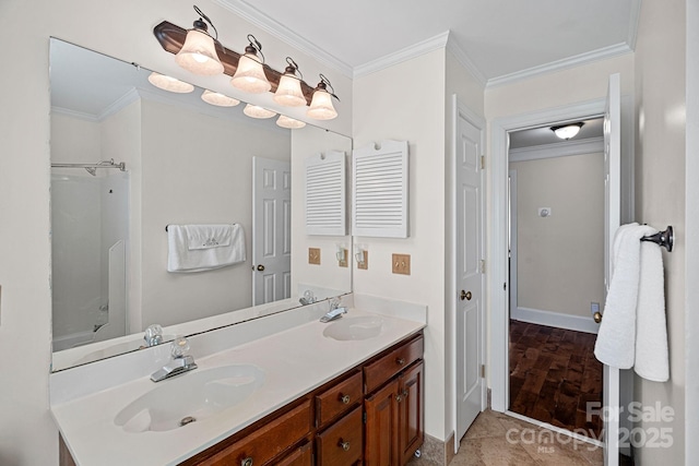 bathroom with a sink, baseboards, ornamental molding, and double vanity