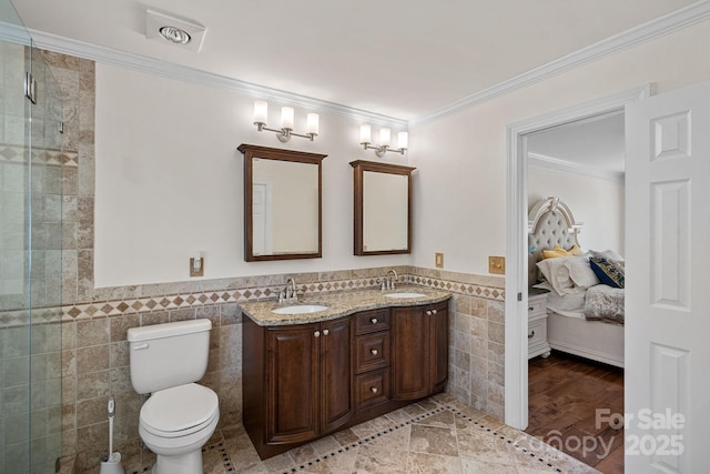 ensuite bathroom with ensuite bath, ornamental molding, tile walls, and a sink