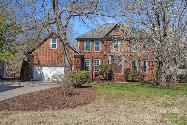 view of front facade with a front lawn, brick siding, and driveway