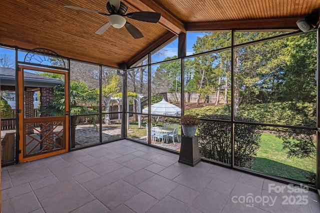 unfurnished sunroom with wooden ceiling, lofted ceiling with beams, and ceiling fan