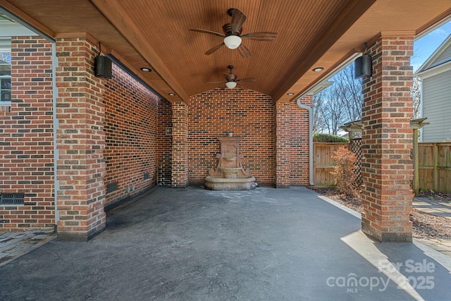 view of patio featuring ceiling fan and fence