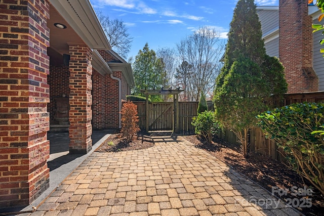 view of patio / terrace featuring a gate and fence