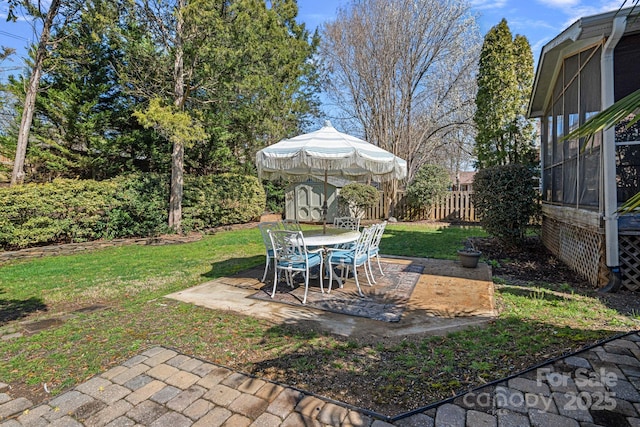 view of yard with a patio, a storage unit, fence, and an outdoor structure